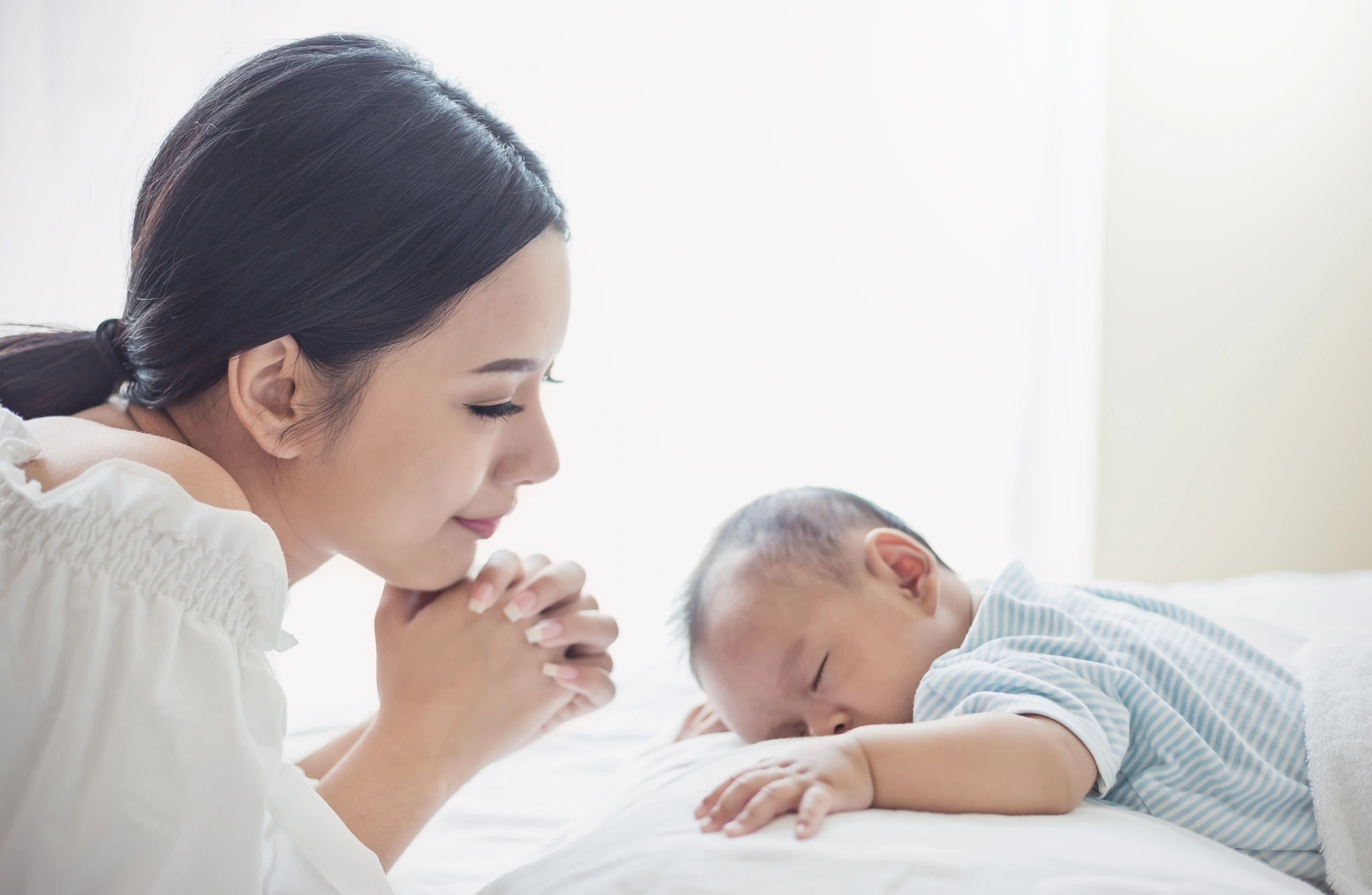 Mother holding her newborn in a hospital setting