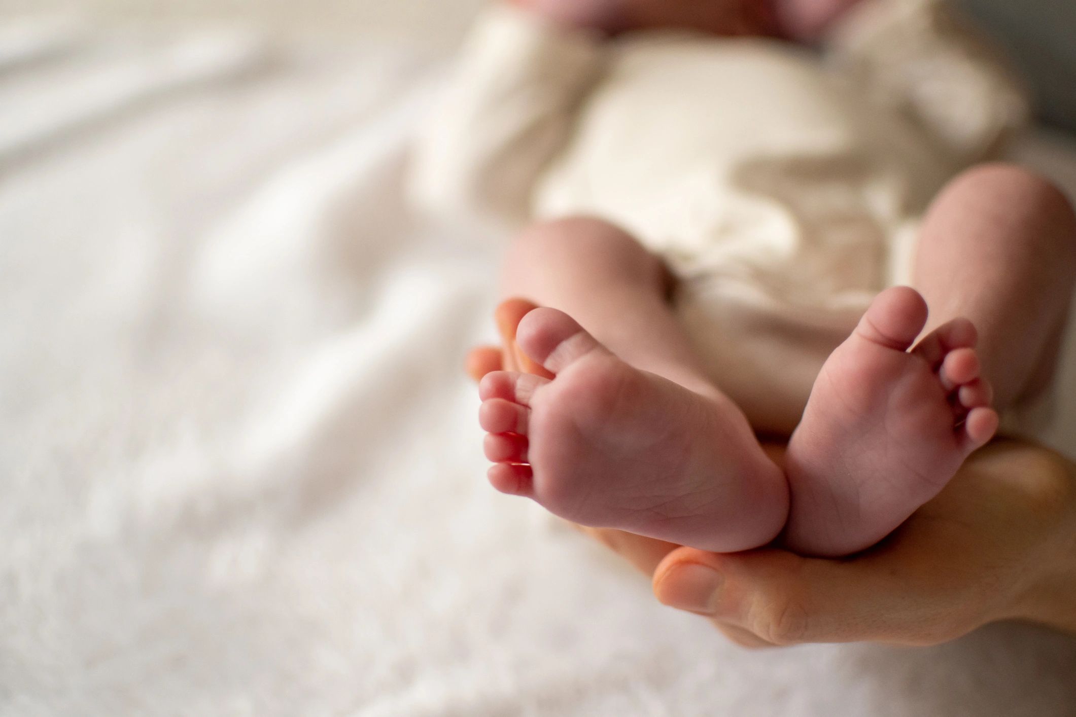 Mother holding baby's feet