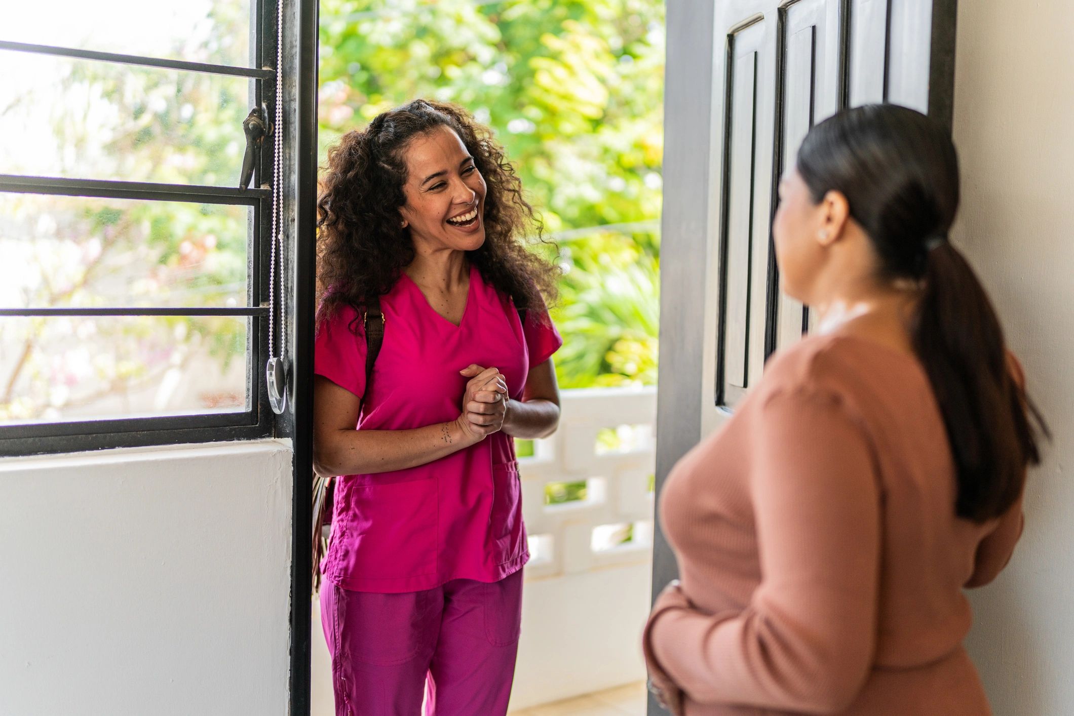 Expecting parent greeting a nurse at home