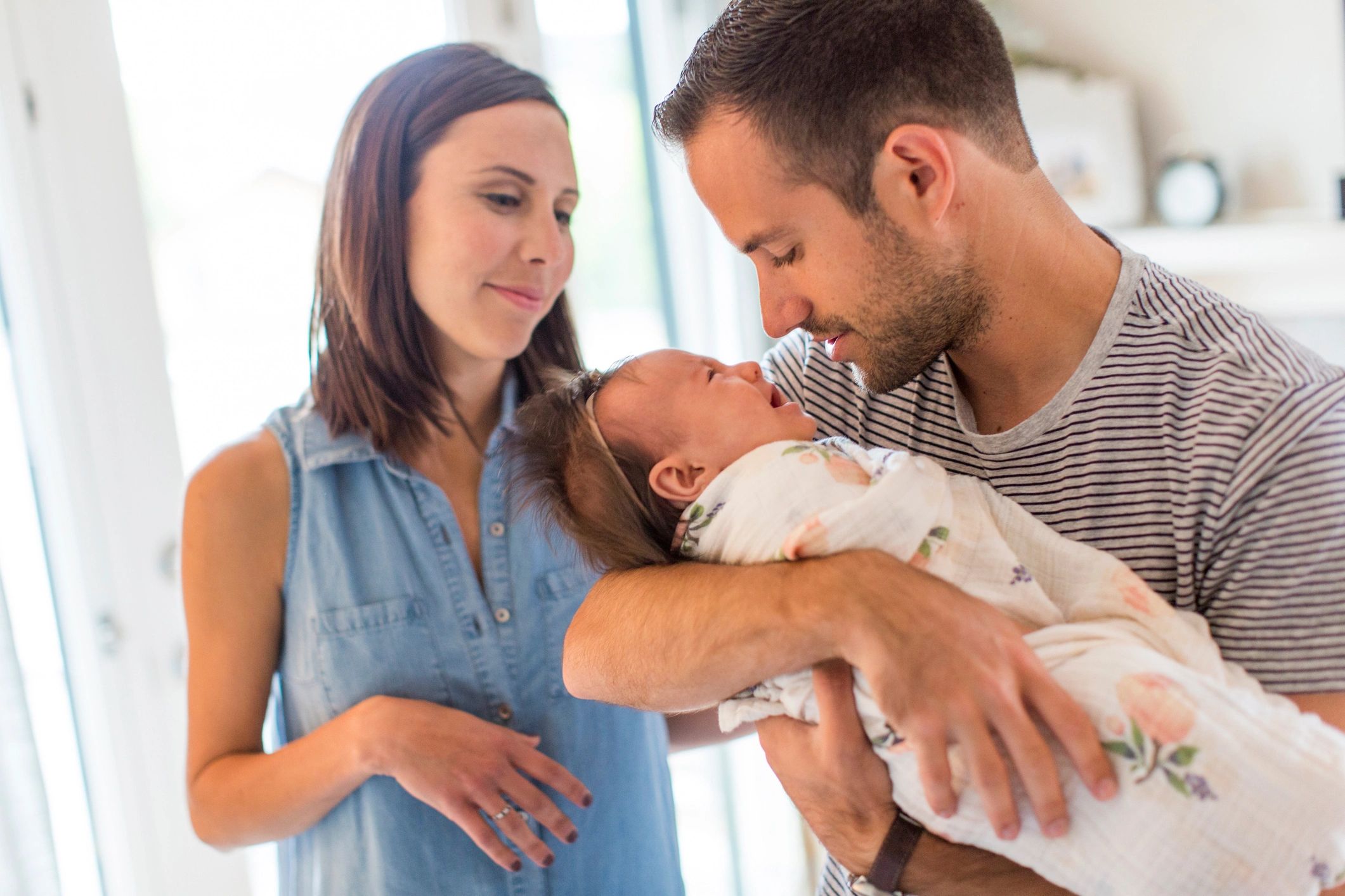 Parents holding their newborn together