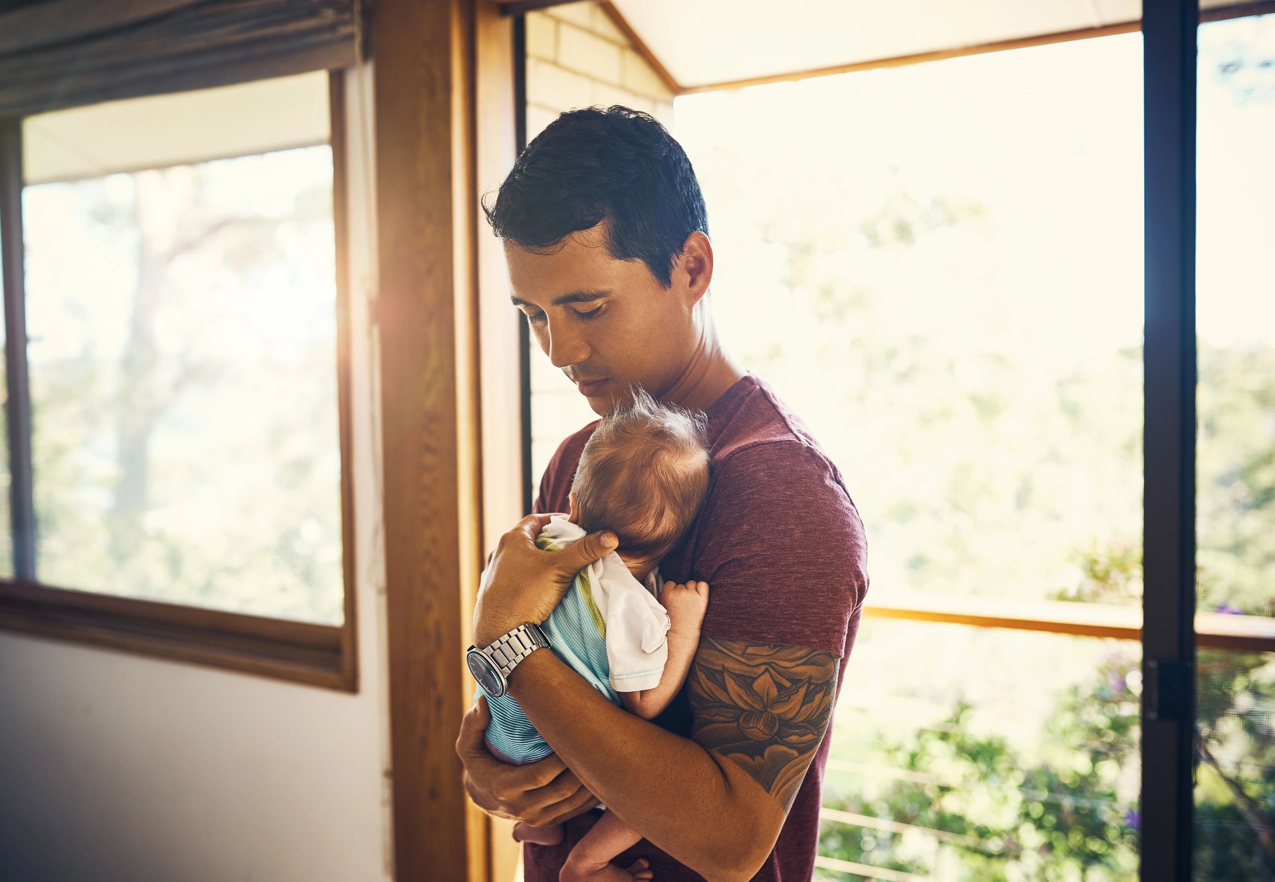 Parent holding a newborn at home